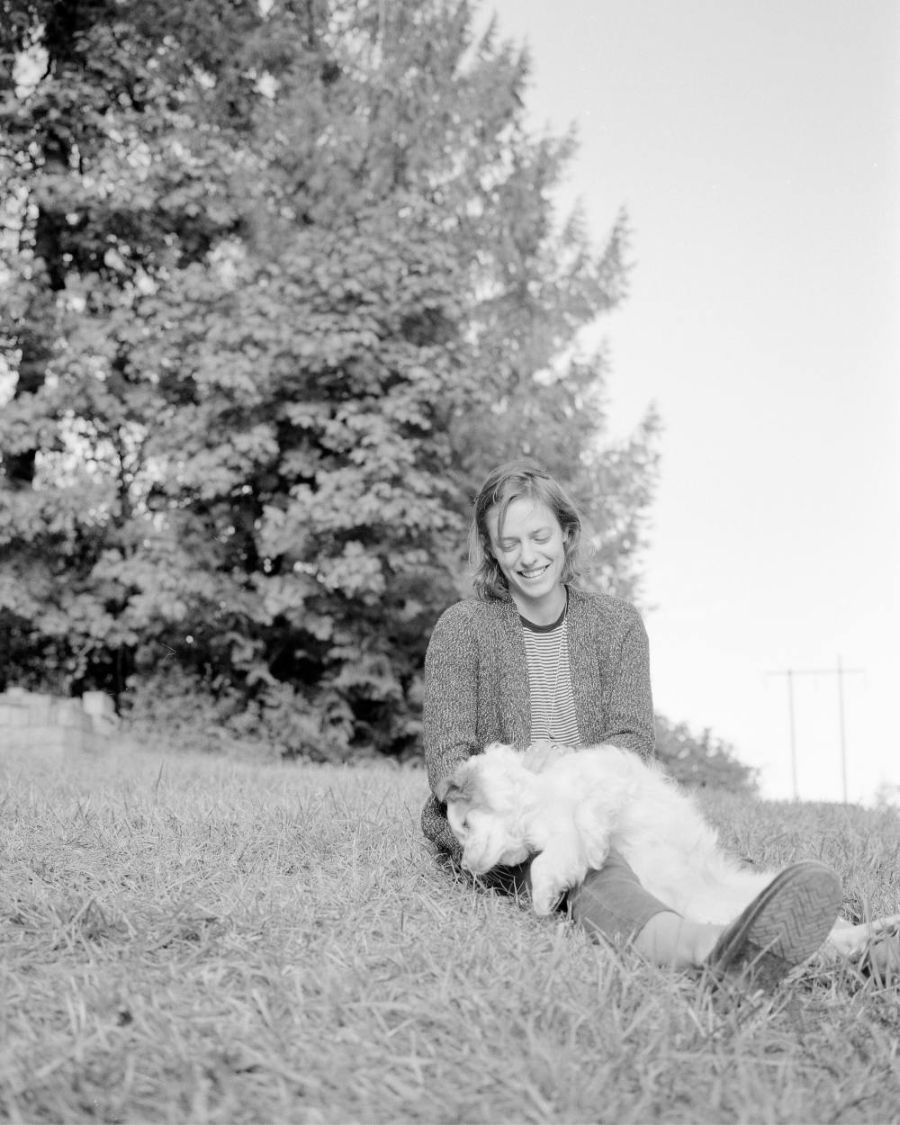 Kendall and dog in field - By Arthur Hitchcock